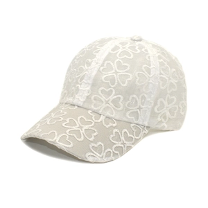 Chic beige baseball cap featuring hollow heart embroidery and breathable mesh sun protection