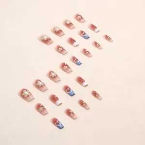 Cute blush pink press-on nails with daisy flower and star designs in a medium long length