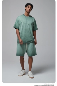 Detail of men's vintage washed green short set featuring drop shoulder tee and drawstring shorts