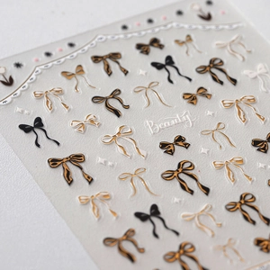 3D embossed bow nail stickers with gold foil, black and white stars for elegant nail art
