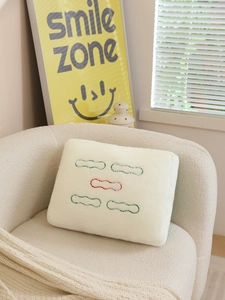 Detailed close-up of Mahjong Five Bamboo plush pillow with green and red embroidery on sofa