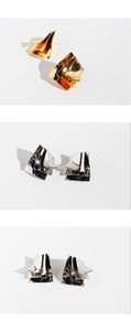 Macro shot of tiered irregular geometric metal earrings in gold and silver finish