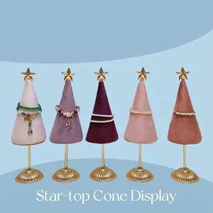 Five velvet cone jewelry displays with gold stars and brass bases for bracelets