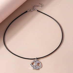 Close-up of gothic skull pendant on black braided cord with adjustable chain necklace