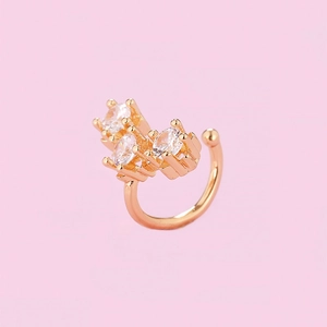 Detailed view of a gold-plated ear cuff featuring three sparkling claw-set cubic zirconia