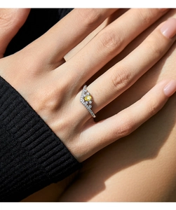 Detailed view of s925 silver crown ring with water drop yellow stone on model hand
