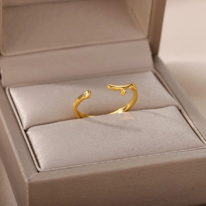 Detailed close-up of rose gold open heart ring with cubic zirconia inside a beige jewelry box