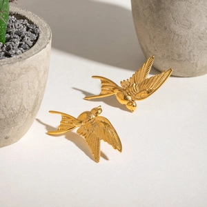 Minimalist gold stainless steel peace dove earrings with detailed feather texture