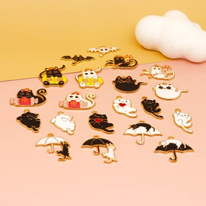 Detail of Halloween enamel black and white cat charms with bat and umbrella designs