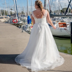 Elegant plus size white wedding dress with deep V back, lace appliques and tulle train
