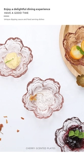 Close-up of pink cherry blossom glass dipping plates with hammered texture on white background