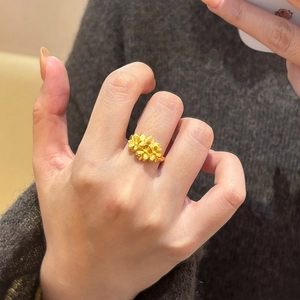 Elegant gold plated floral open ring featuring three matte 3D flowers on woman's hand