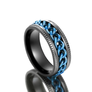 Macro shot of rotatable deep blue chain on black stainless steel industrial ring