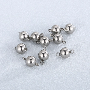 Close-up of polished stainless steel spherical bead connectors for DIY jewelry making