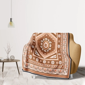 Detail of bohemian mandala pattern throw blanket draped over a modern fabric sofa