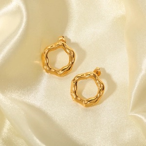 Irregular geometric lava earrings in 18K gold plated stainless steel on silk background