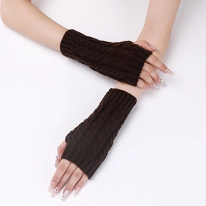 Close-up of cable knit texture on dark brown fingerless winter wrist warmers