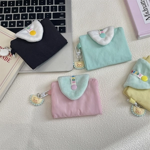 Macro view of four pastel canvas coin purses with plush flaps and bear charms