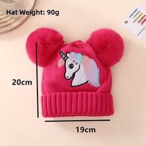 Detail view of pink knitted girl's unicorn hat with twin pom-poms and size dimensions