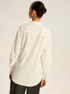 Back view of white long-sleeved shirt with lapel collar and box pleat detail