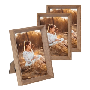 Three solid wood photo frames in light grain finish with desktop easel backs on white background