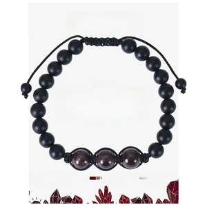 Macro detail of garnet bead bracelet with woven cord and energy card description