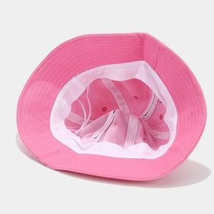 Detailed interior of a pink bucket hat showing breathable mesh lining and white sweatband