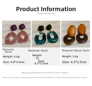 Detailed view of geometric resin and wood earrings with marble texture and wood accents