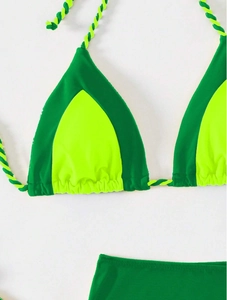 Detail of neon yellow bikini top with dark green edges and braided tie straps