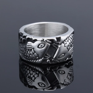 Macro view of vintage silver fish relief patterns and brushed metal inner ring surface