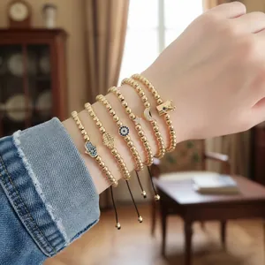 Five-piece gold beaded bracelet set with Hamsa hand, evil eye, star and moon charms
