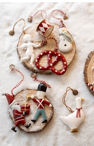 Detailed view of assorted Nordic Christmas metal ornaments arranged on a wooden base