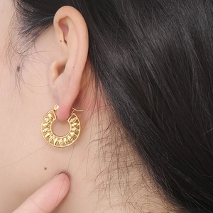 French style gold hollowed leaf hoop earrings in stainless steel on ear model