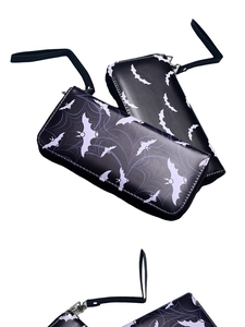 Detail of long zipper wallets featuring retro bat and spider web patterns with hand straps