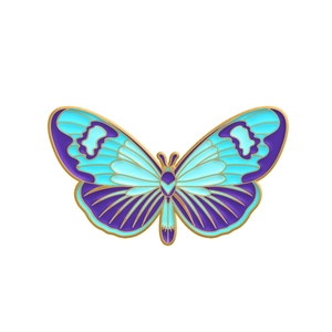 Detail shot of the butterfly enamel brooch showing blue and purple gradient wings