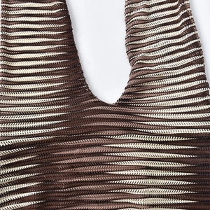 Close-up of zigzag wave pattern knit fabric on a halter neck bodycon maxi dress