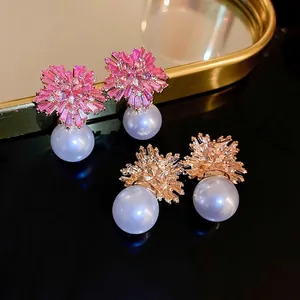 Elegant floral pearl stud earrings with pink gemstone inlay and gold vintage design