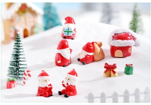 Miniature resin Santa Claus and Christmas tree scene with white snow landscape details