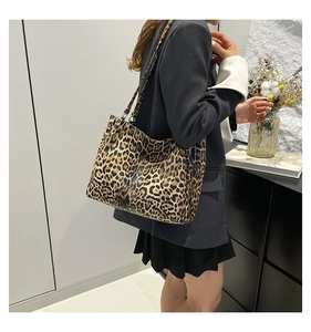Detailed side view of large leopard print tote bag worn on shoulder for stylish daily commute