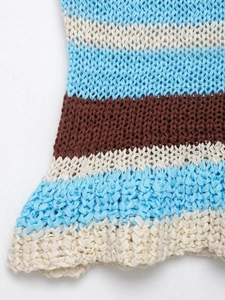 Detail of multi-color striped crochet knit top with light blue and beige openwork texture