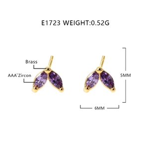 Macro shot of gold leaf stud earrings with purple zircon measuring 5mm by 6mm