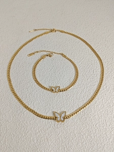 Detail of 18k gold butterfly necklace and bracelet set with white shell inlay