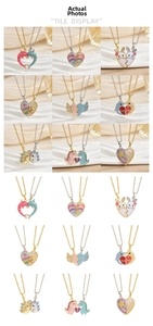 Detail of 18k gold plated magnetic heart necklaces with colorful enamel patterns
