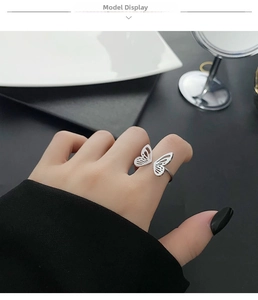 Close-up of a silver-toned butterfly open ring featuring intricate hollow-out wings