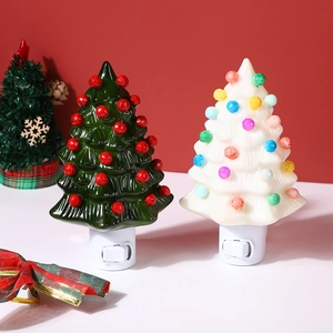 Detail of green and white ceramic Christmas tree night lights with colorful LED beads