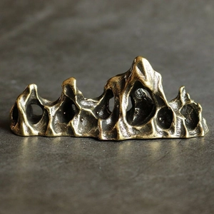 Close-up of a solid brass rockery sculpture with vintage bronze texture and hollow design