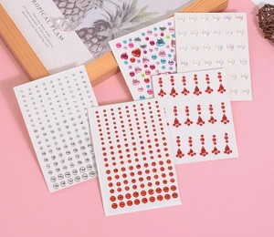 Detail of 5 sheets self-adhesive facial rhinestones in round, heart and teardrop shapes