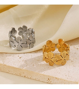 Détails de bagues fleurs en acier inoxydable plaqué or 18K et argent sur support pierre
