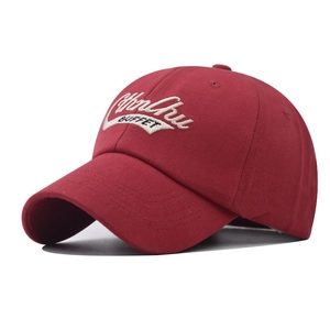 Close-up of embroidered ChuChu BUFFET logo on burgundy cotton twill baseball cap