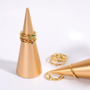 Detailed close-up of gold titanium rings with colorful December birthstones on cones